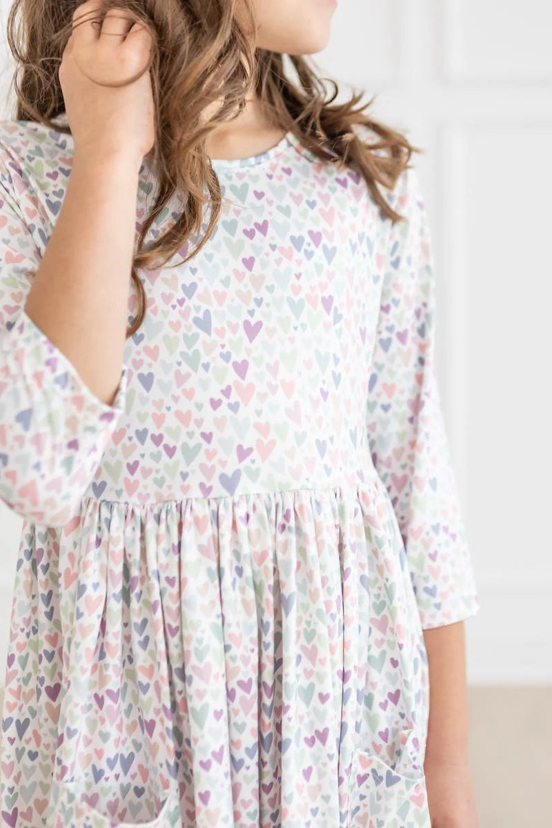 Girl wearing white dress with light Purple Heart print