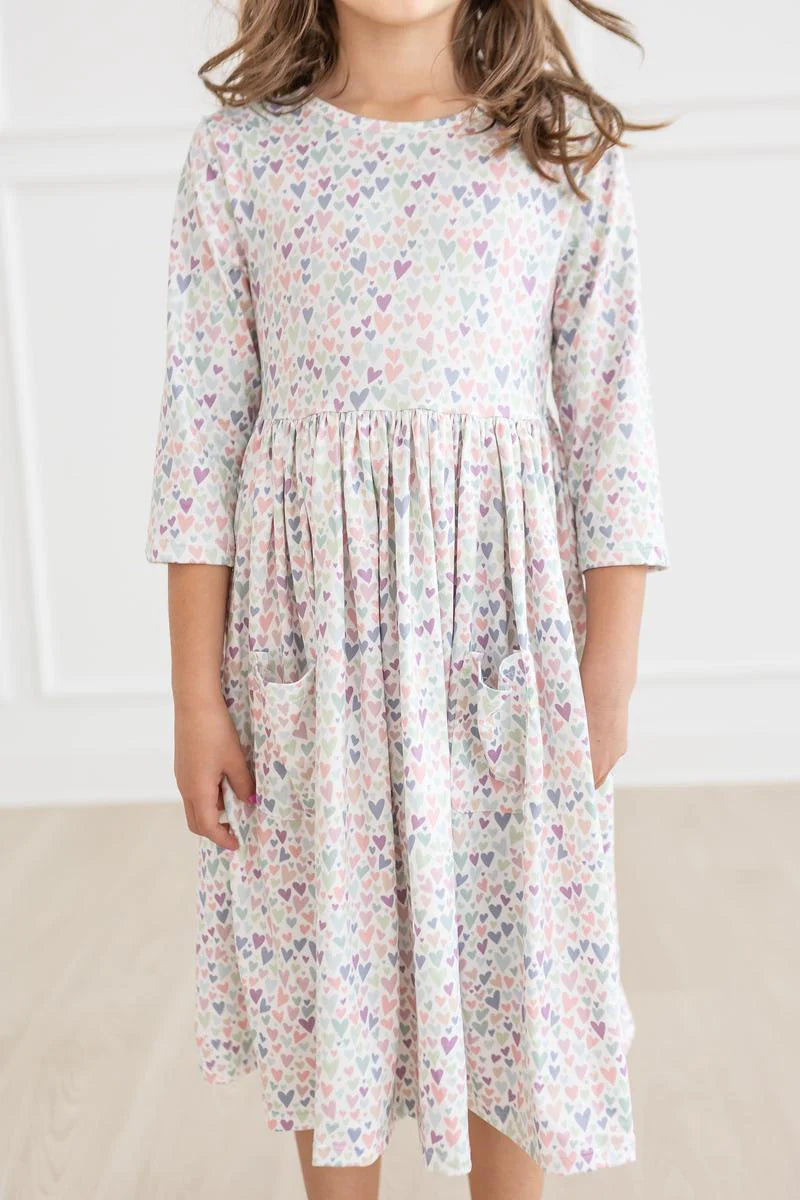 Girl wearing white dress with light Purple Heart print