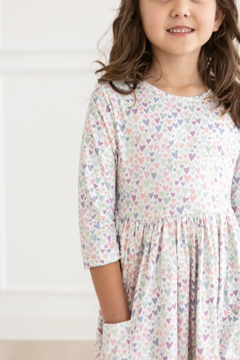 Girl wearing white dress with light Purple Heart print