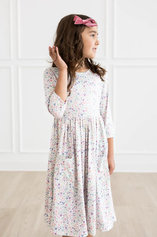 Girl wearing white dress with light Purple Heart print