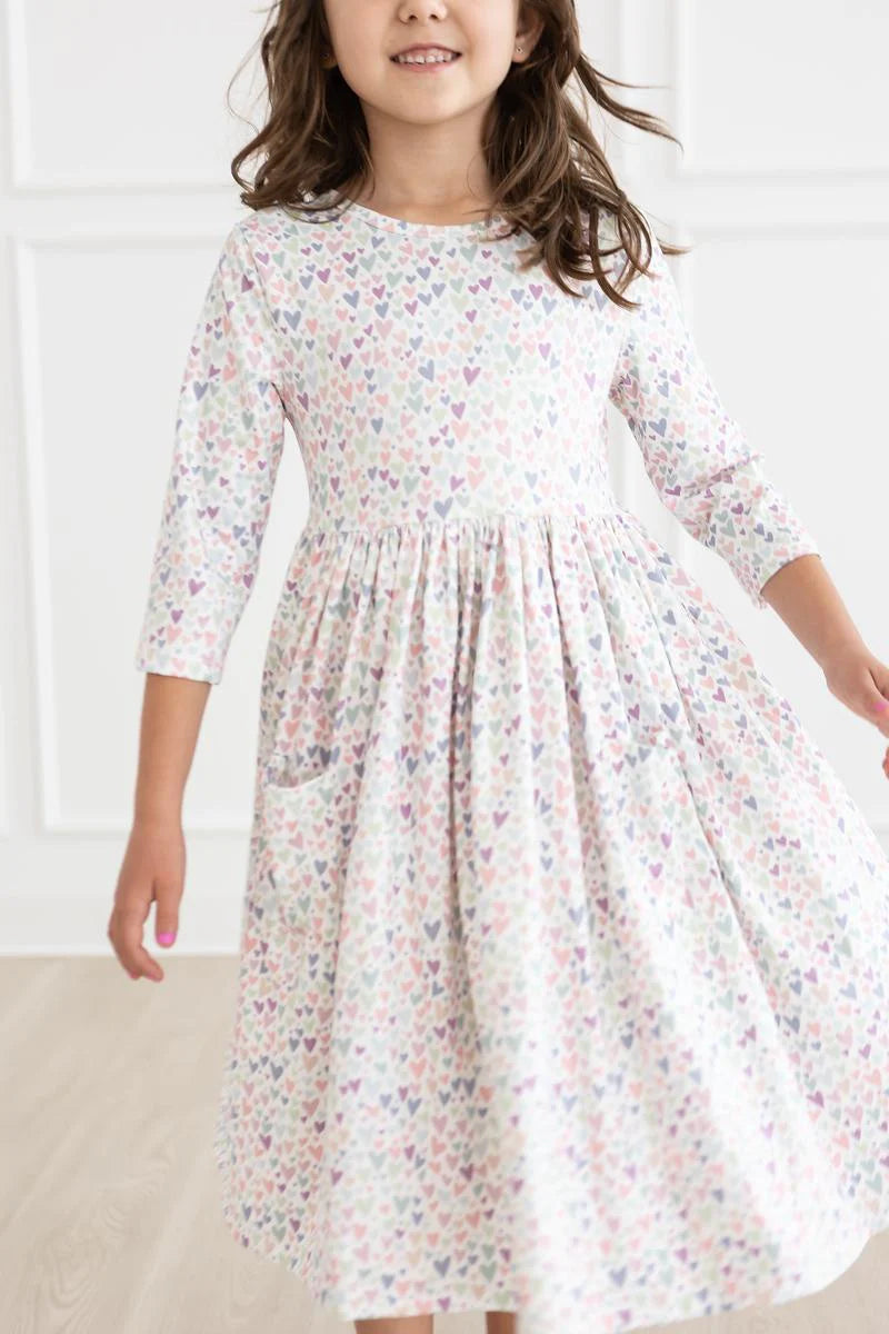 Girl wearing white dress with light Purple Heart print