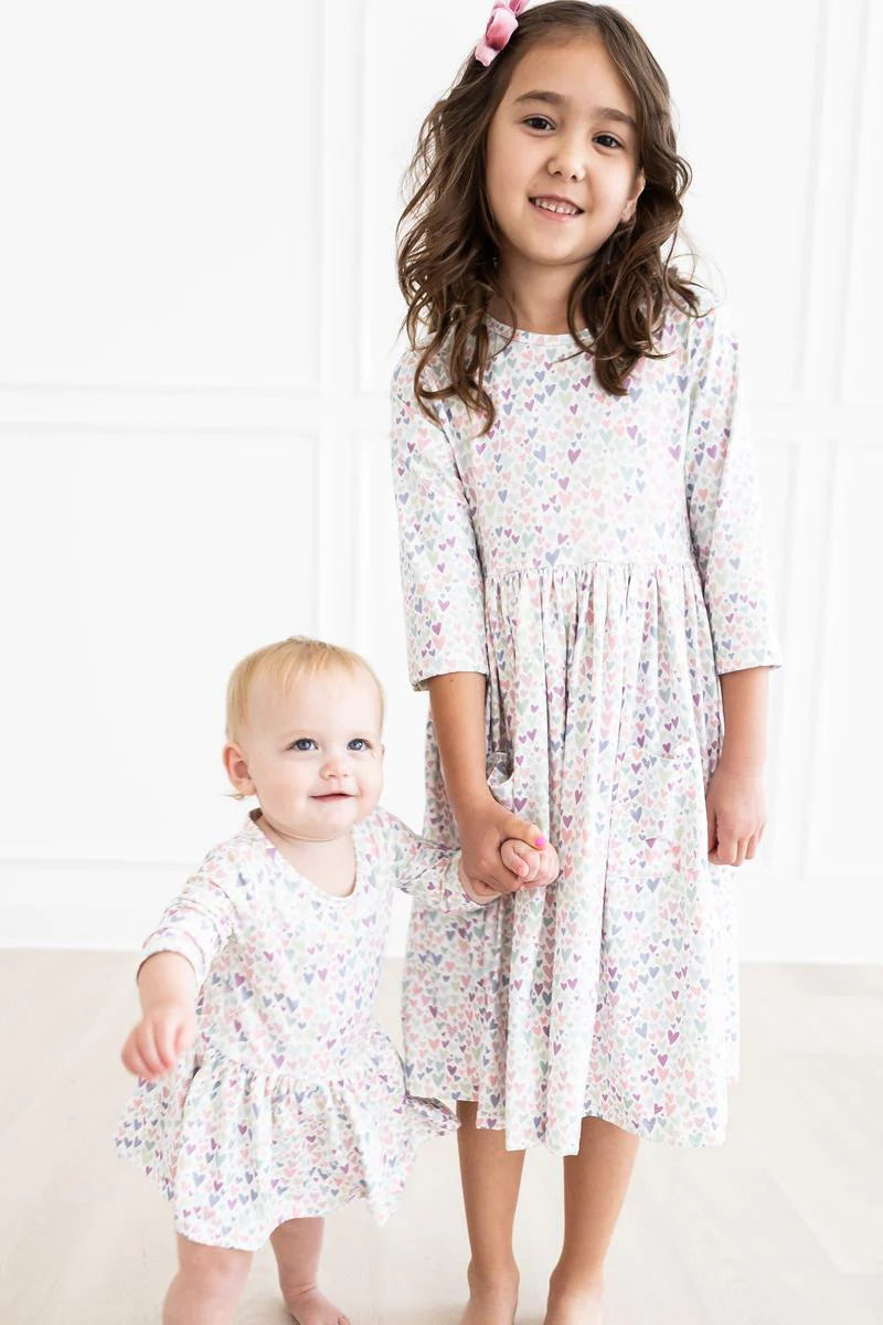 Girl wearing white dress with light Purple Heart print